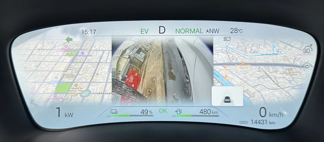BYD instrument cluster showing a live blind-spot camera view between navigation panels