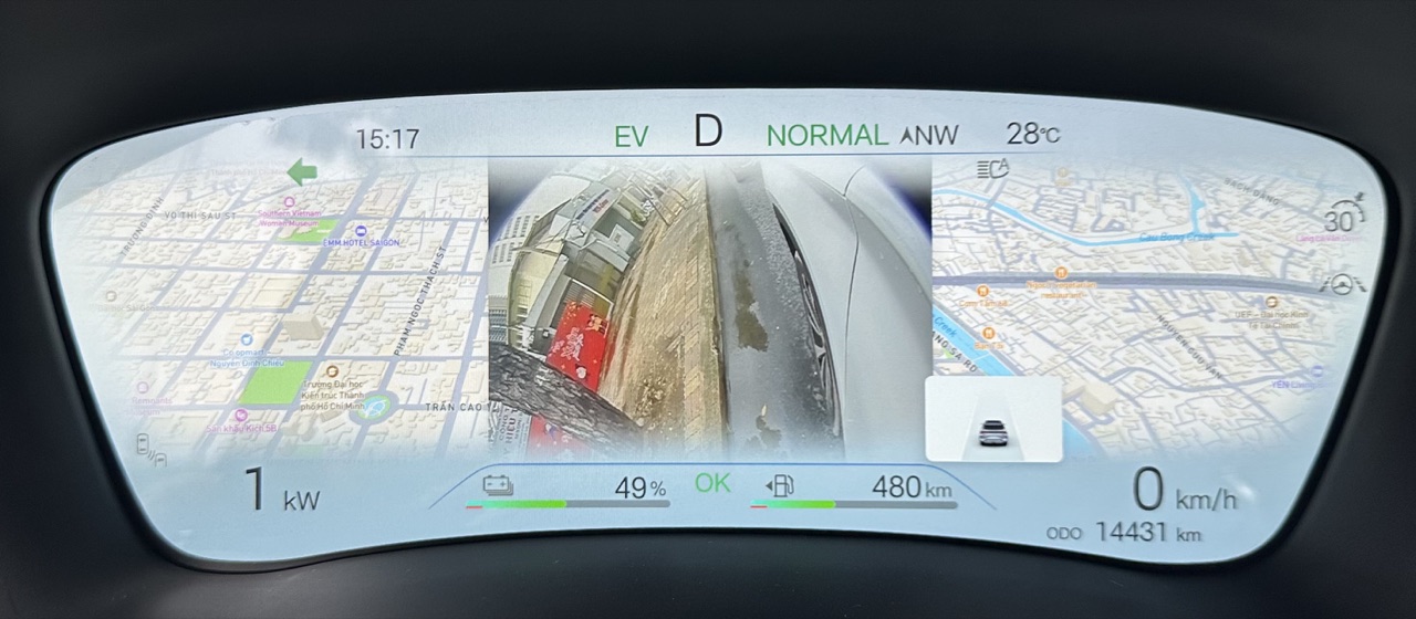 BYD instrument cluster showing a live blind-spot camera view between navigation panels